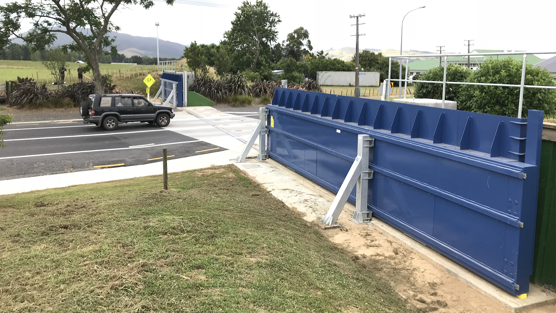 Image of a floodgate in working order across a road