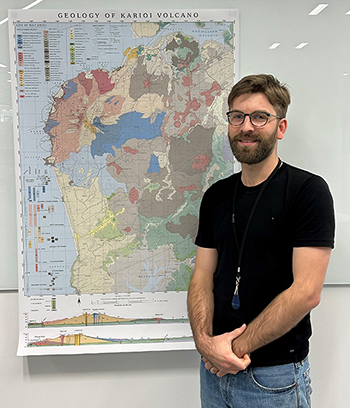 Image - Oliver McLeod stands alongside his volcanic map of Karioi