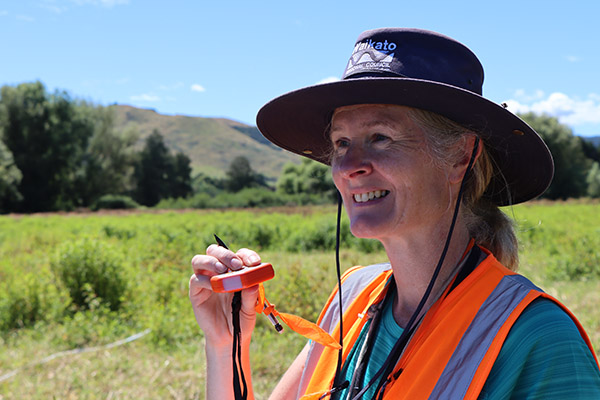 Image: Dr Liz Overdyck reads the slope of the site with a digital inclinometer.