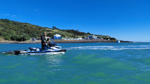 Waikato Regional Council maritime officer on a jet ski patrolling the exclusion zone during the WSL competition