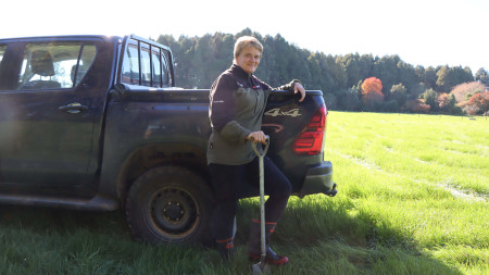 Image of someone holding shovel and standing with ute