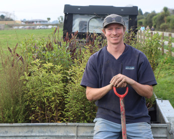 Waikato Regional Council River Management Officer James Lineham sitting on the planting trailer ready for the day