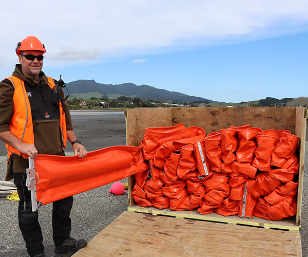 The booms need to be unrolled and filled with air and water.