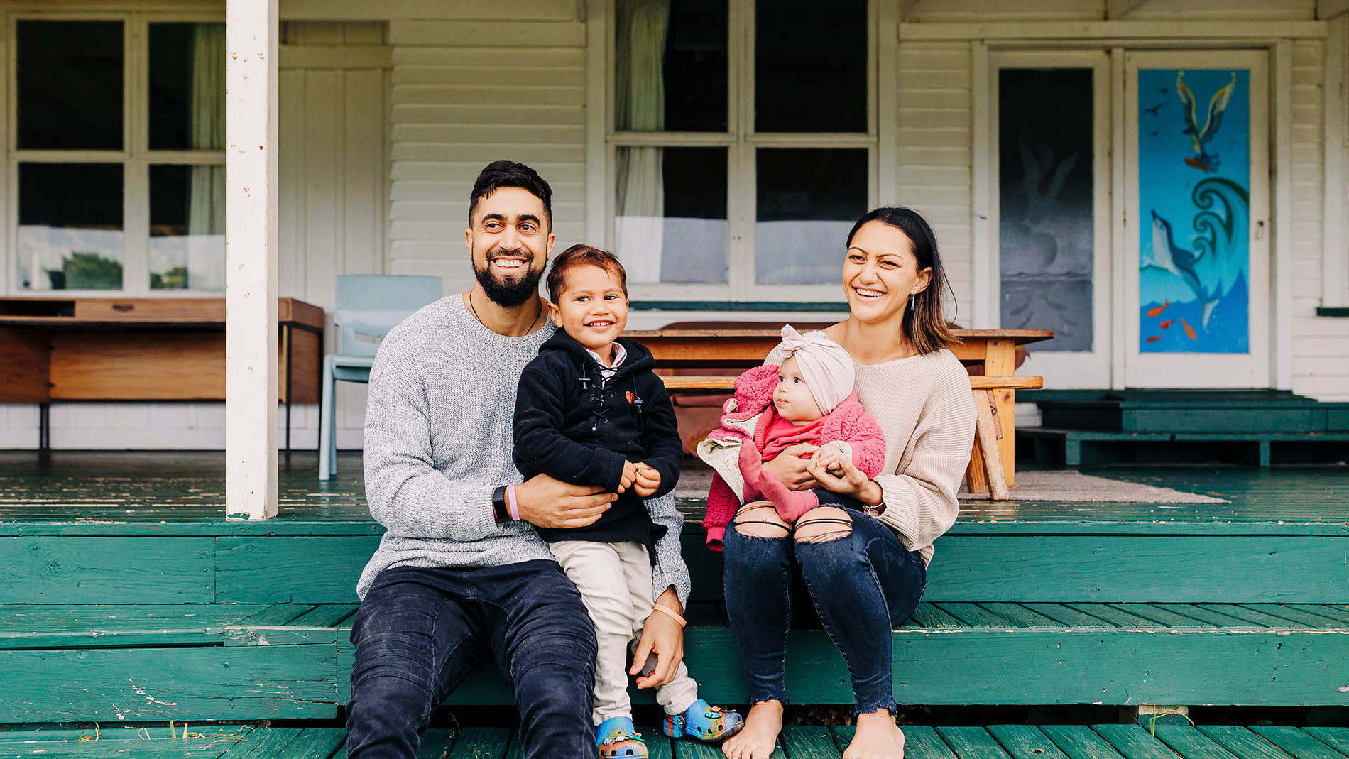 Image - family sitting on deck at Raglan