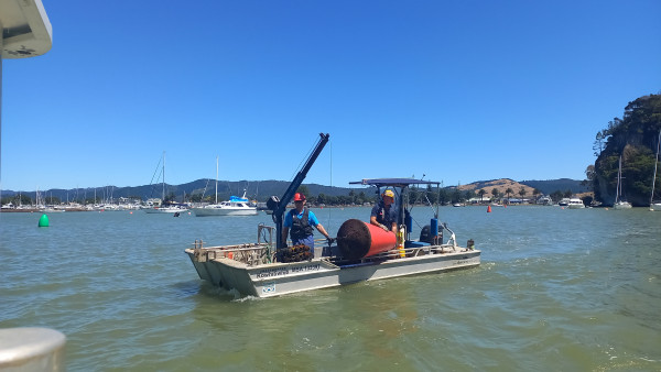 Waikato Regional Council maritime officers reposition a channel marker moved by strong and unusual currents.