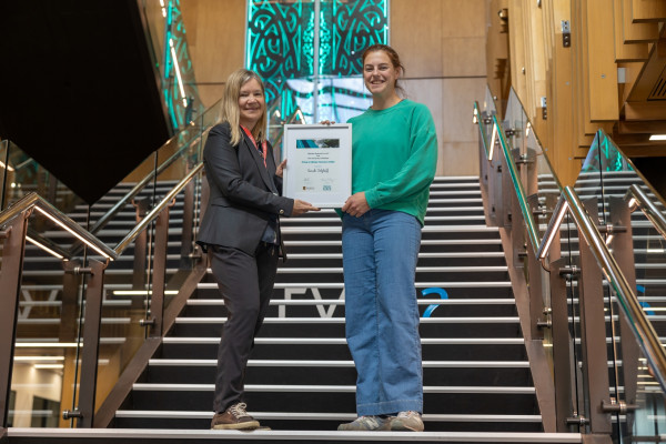 Joanne Ellis (left) presents Sarah with her award